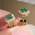 Gold drop earrings with faceted green crystal pendants. By Sophi.