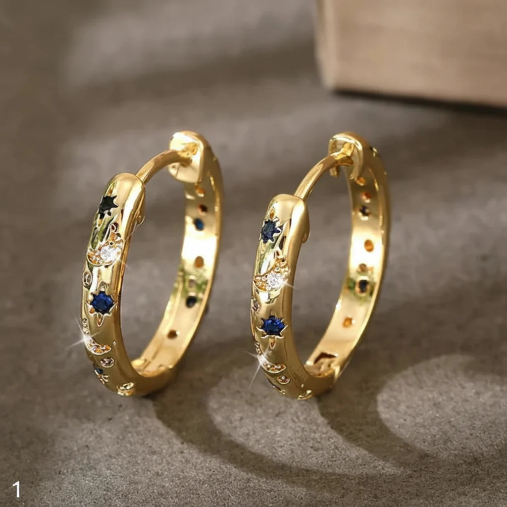 Vintage gold hoop earrings with deep blue front accent. By Sophi.