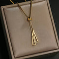 Long gold-toned chain ending in a slim tassel pendant. By Sophi.