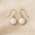 By Sophi Vintage Opal Stone Gold Earrings flat-lay on warm cream