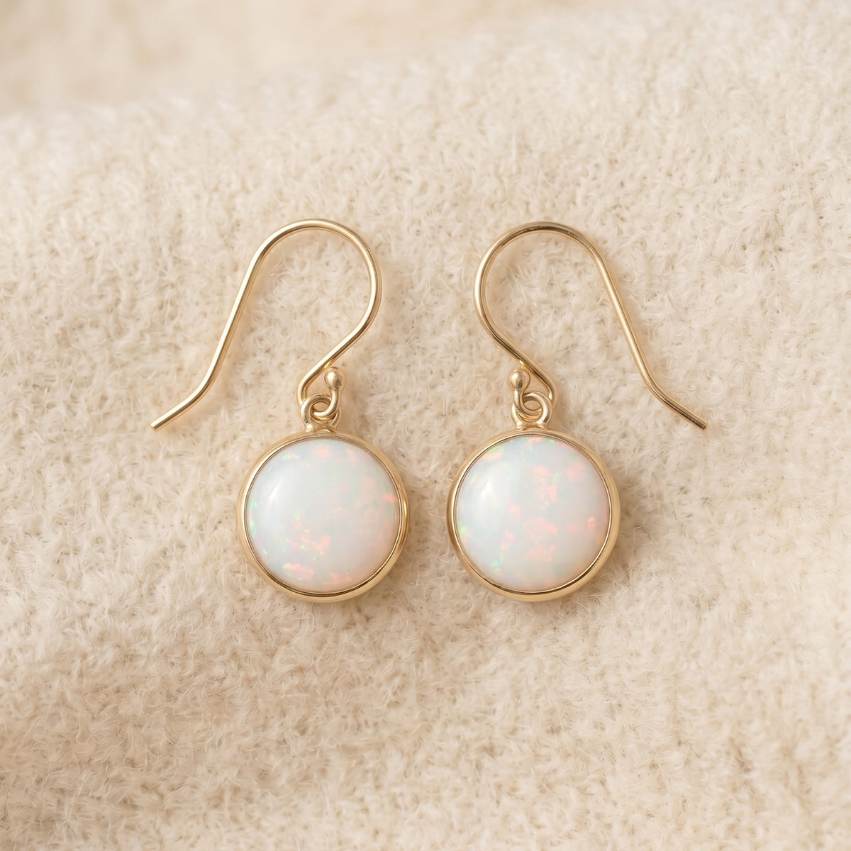 By Sophi Vintage Opal Stone Gold Earrings flat-lay on warm cream