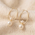By Sophi Vintage Charming Pearl Earrings flat-lay on warm cream
