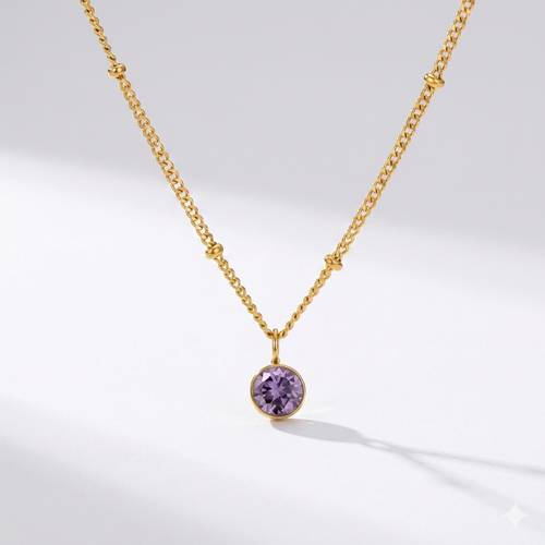 Amethyst birthstone pendant necklace in gold-toned chain. By Sophi.