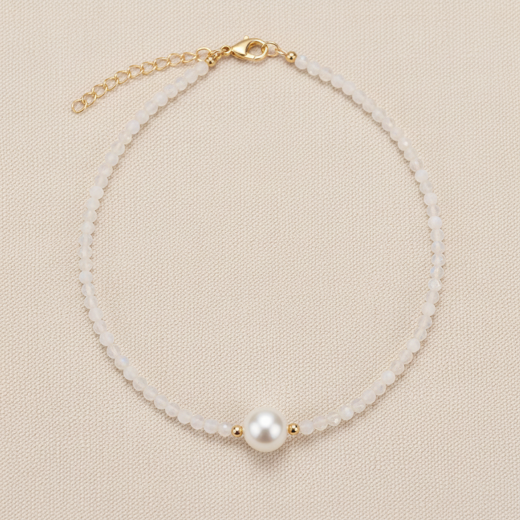 Pearl necklace with a gold clasp on a light gray background