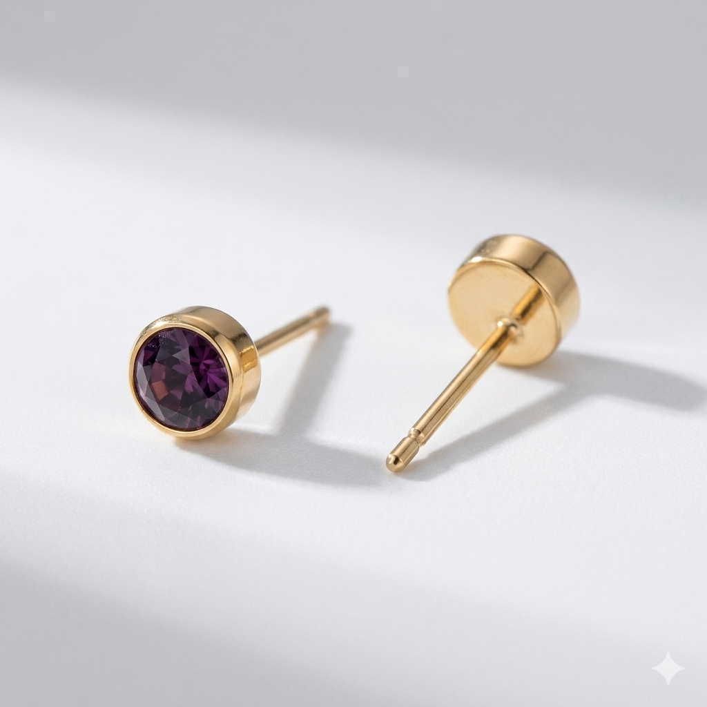 Garnet birthstone stud earrings in gold-toned bezel. By Sophi.