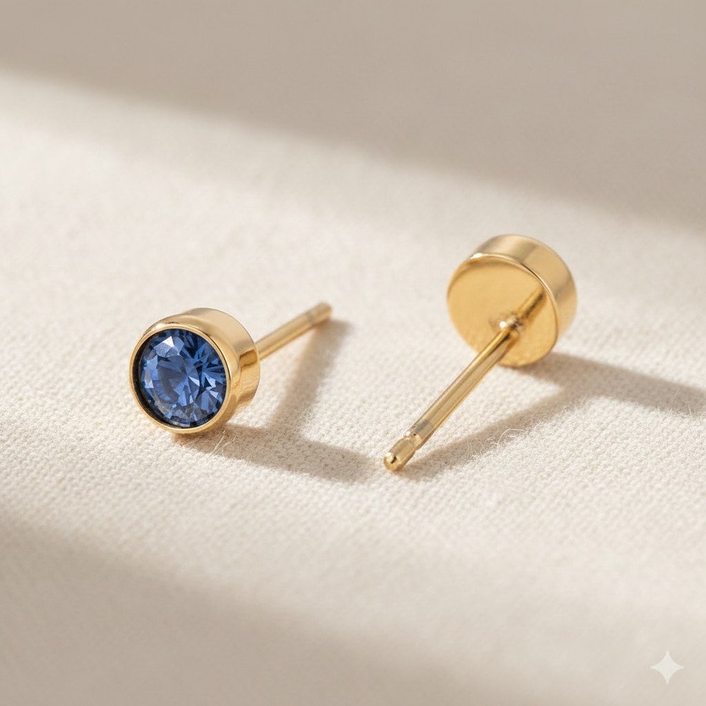 Montana sapphire birthstone stud earrings in gold-toned bezel. By Sophi.