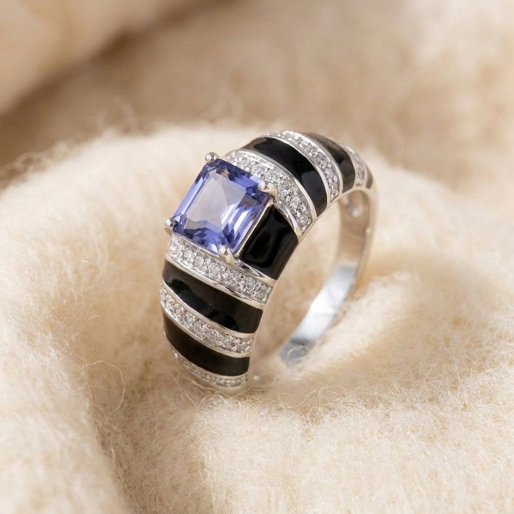 By Sophi Natural Iolite and Black Enamel Ring, catalog macro on warm cream wool, step-cut violet iolite center stone with alternating black enamel and pave shoulders