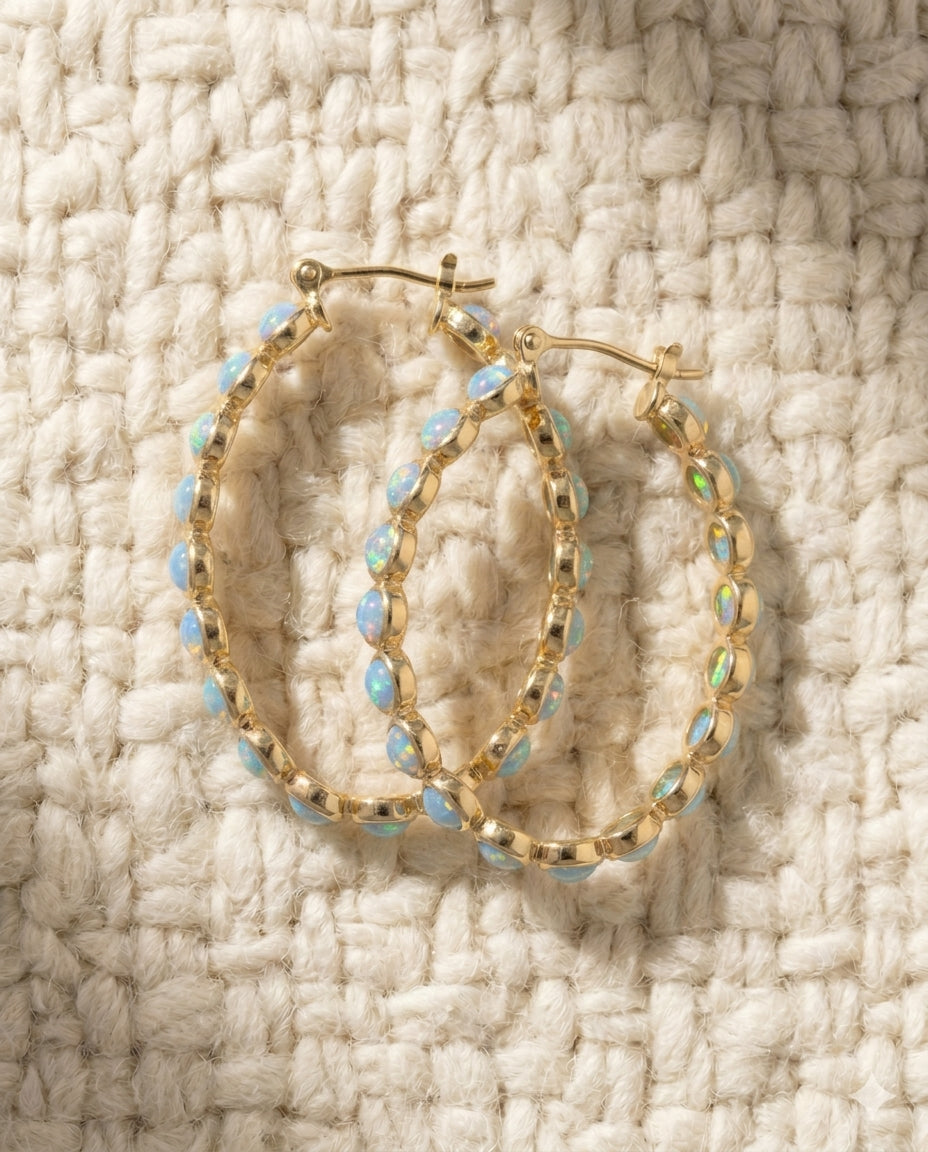 By Sophi Vintage Blue Opal Golden Hoop Earrings flat-lay on warm cream