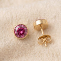 By Sophi Opal Birthstone Studs flat-lay on warm cream