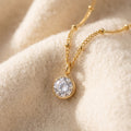 By Sophi April Birthstone Pendant Necklace flat-lay on warm cream wool