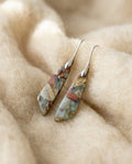 By Sophi Vintage Nature Stone Earrings flat-lay on warm cream wool