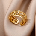 Gold-plated chain ring set with small white crystals along the band. By Sophi.