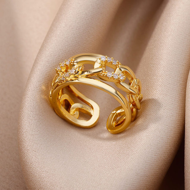 Gold-plated chain ring set with small white crystals along the band. By Sophi.