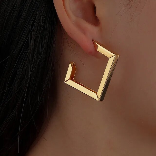 Clean geometric gold stud earrings. By Sophi.