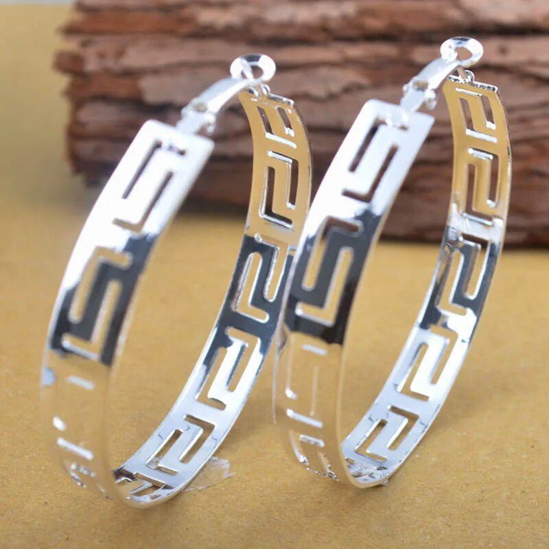 Larger silver hoop earrings with hollow tube construction. By Sophi.