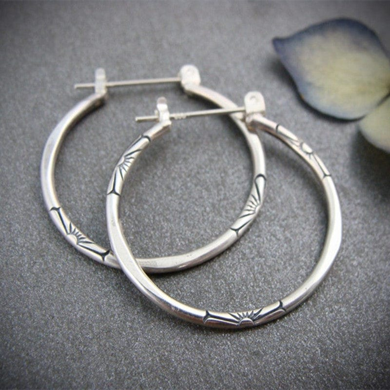 Vintage mid-size silver hoop earrings. By Sophi.