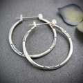 Vintage mid-size silver hoop earrings. By Sophi.