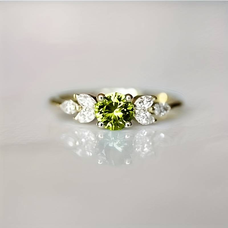 Vintage zirconia ring with olive-shaped bezel in gold tone. By Sophi.