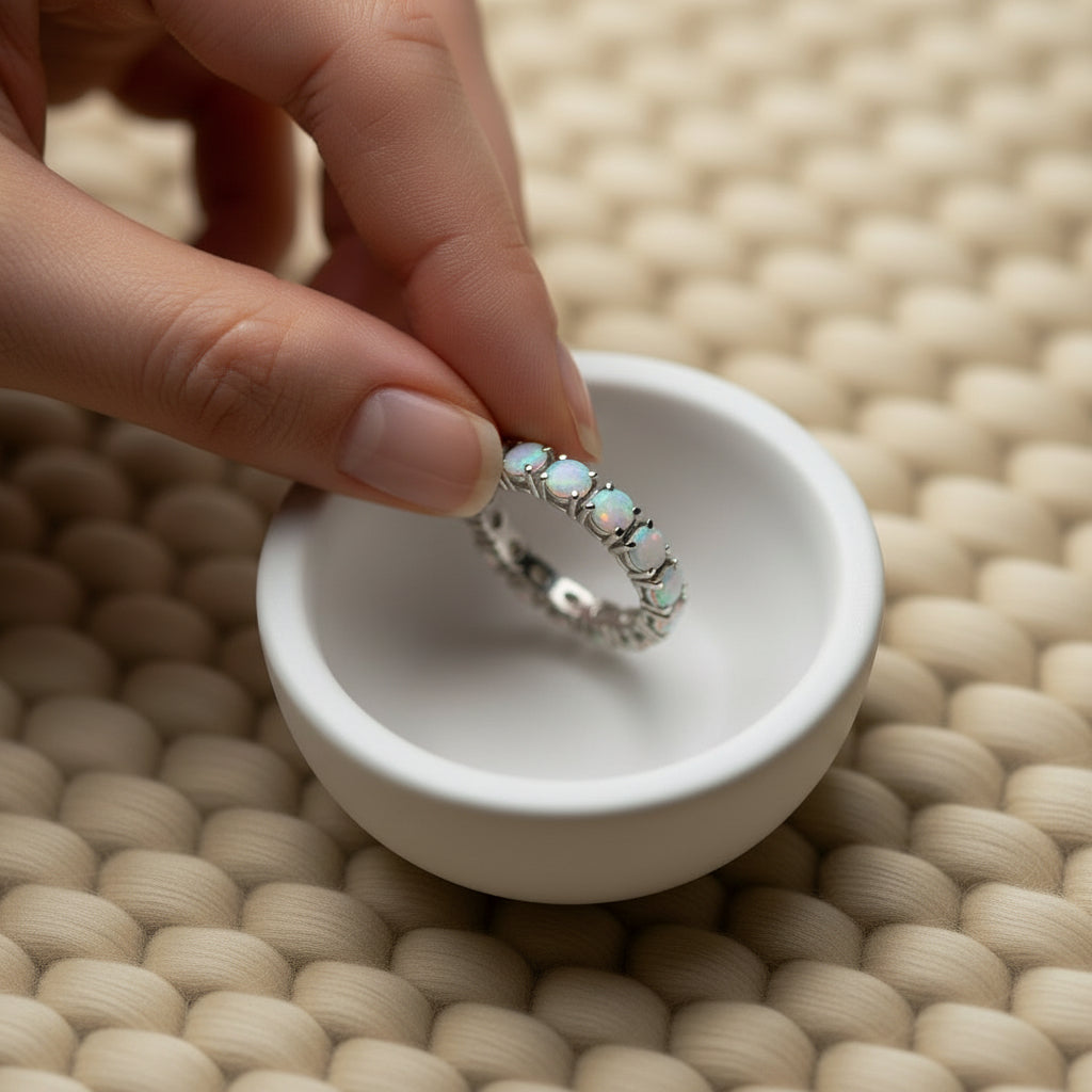 Natural opal eternity band in sterling silver on warm cream wool