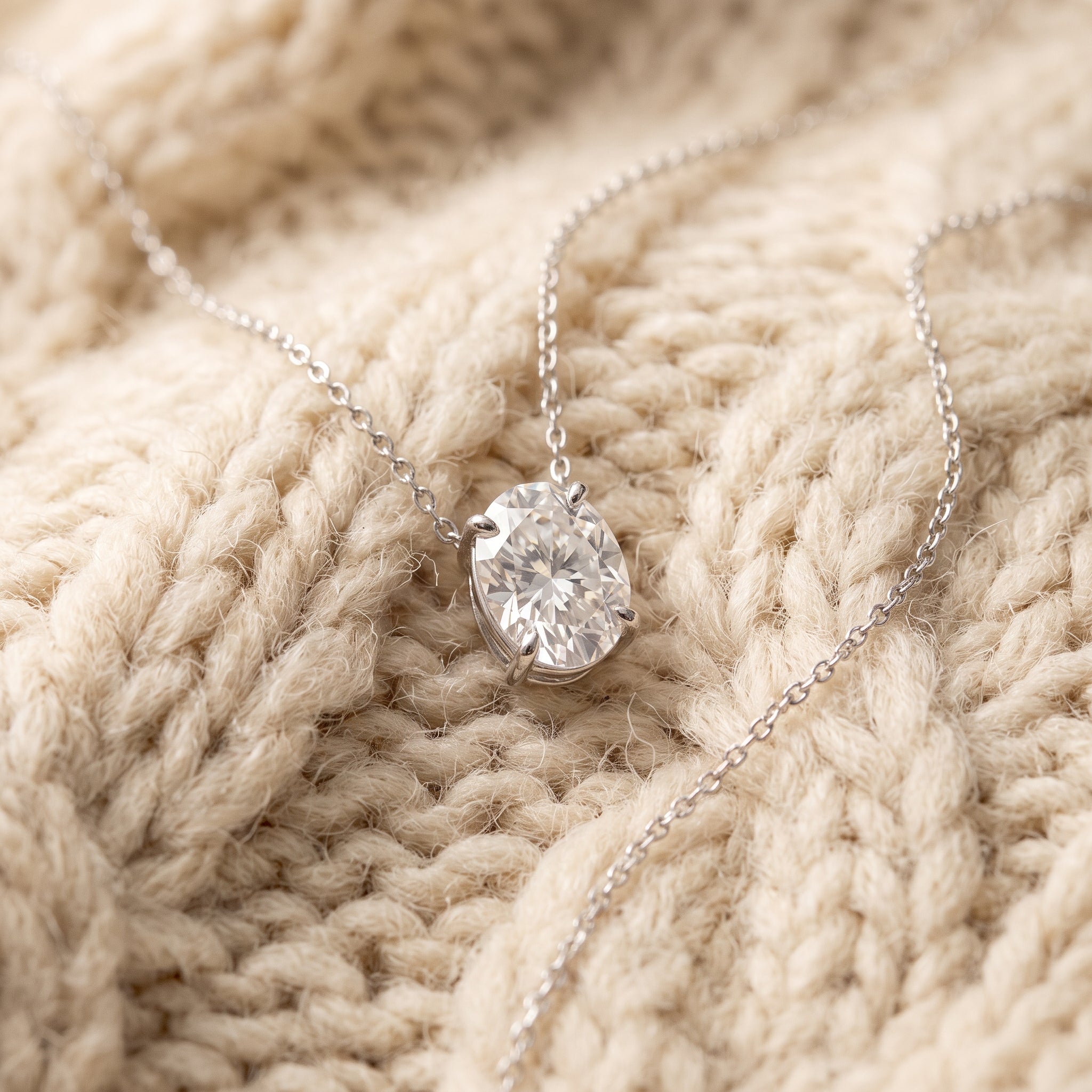 Oval moissanite pendant on warm cream chunky-knit wool, By Sophi