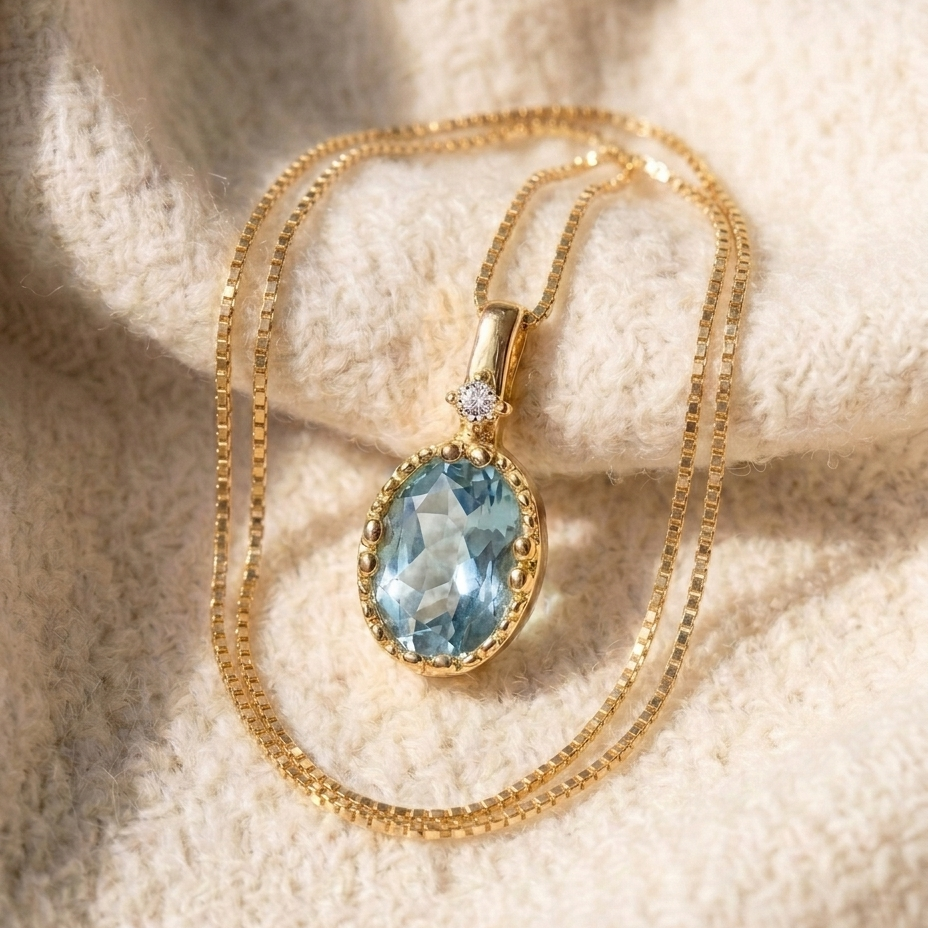 By Sophi Natural Aquamarine Pendant Necklace, catalog flat-lay on warm cream wool