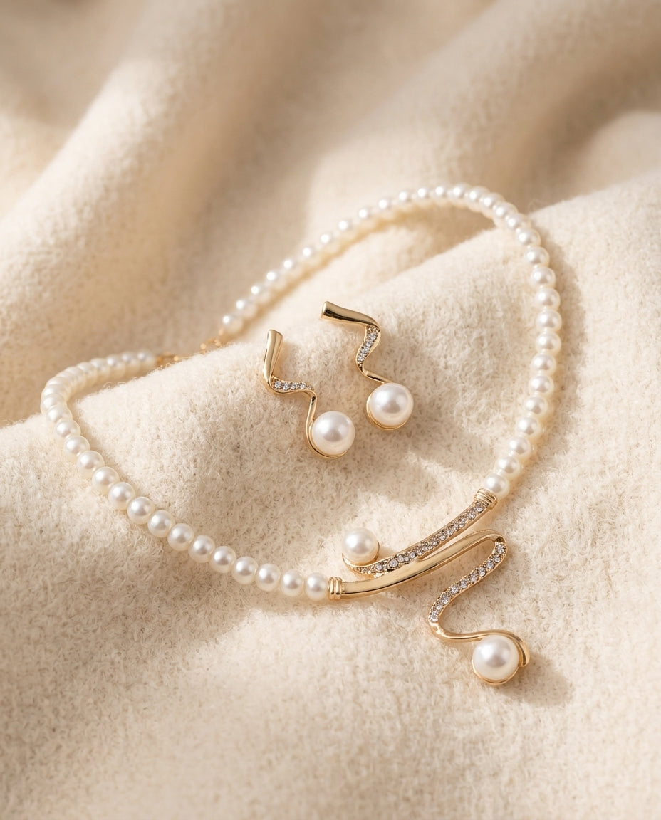 By Sophi Natural Pearl Necklace and Earrings Set flat-lay on warm cream wool