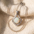 By Sophi Natural Opal Pendant Necklace, catalog flat-lay on warm cream wool