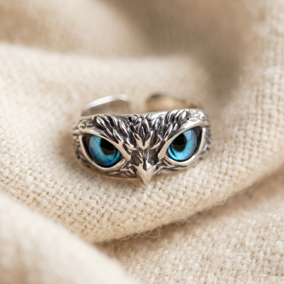 By Sophi Owl of Good Luck Adjustable Ring in Silver and Opal flat-lay on warm cream wool