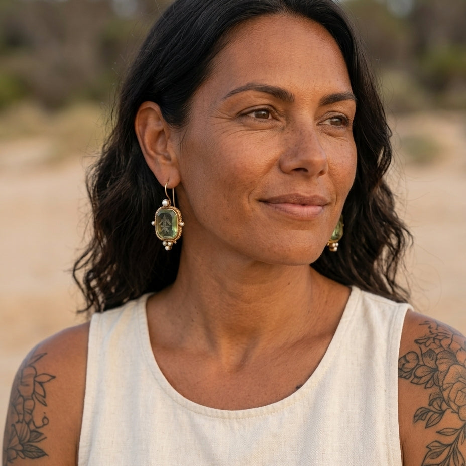 Vintage green and pearl earrings on an Indigenous Australian woman in a coastal setting