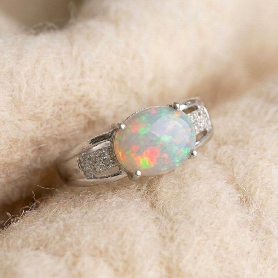 By Sophi Colorful Natural Opal Ring, catalog flat-lay on warm cream wool