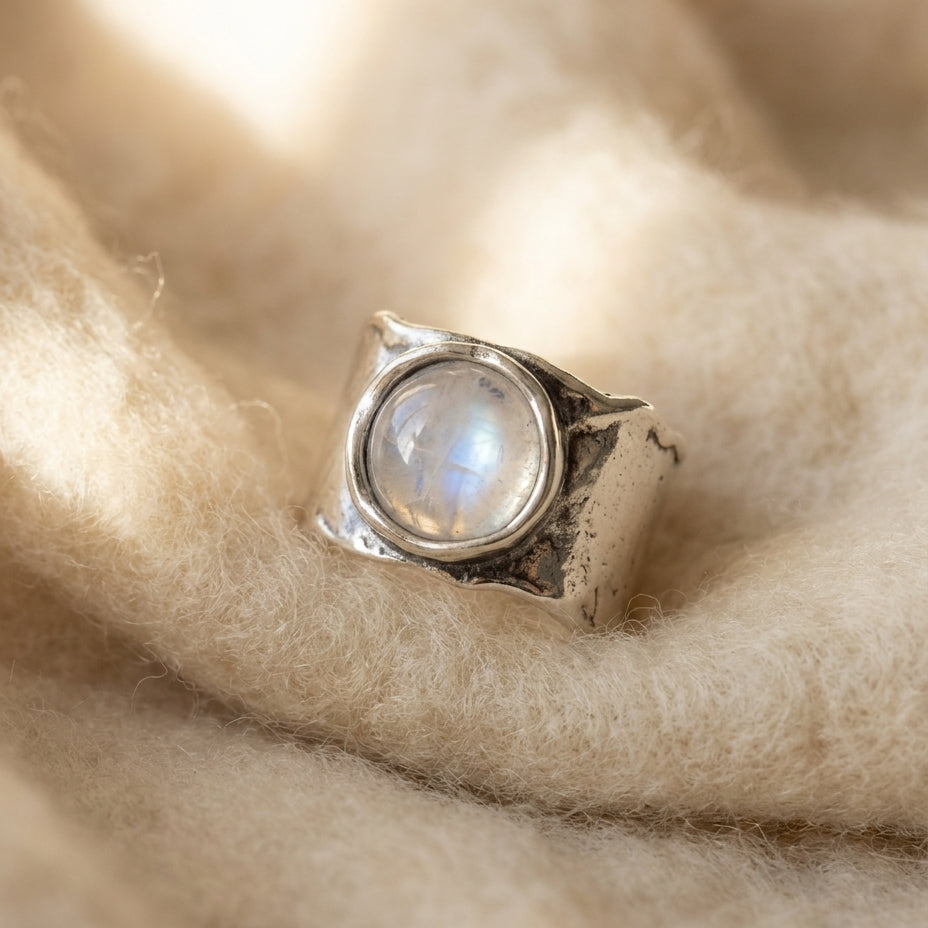 By Sophi Silver Moonstone Ring flat-lay on warm cream wool