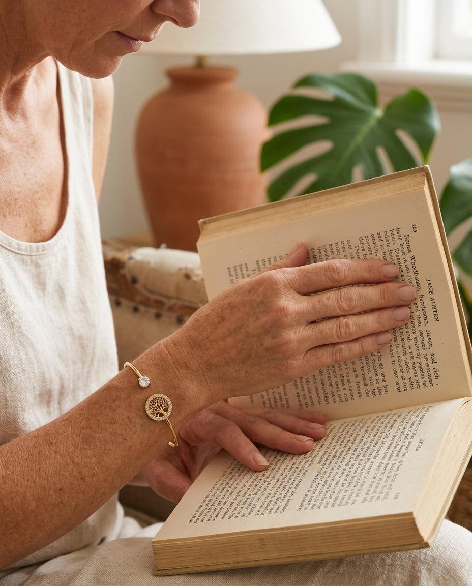 Tree of Life Adjustable Bracelet worn while reading, cream linen, morning light