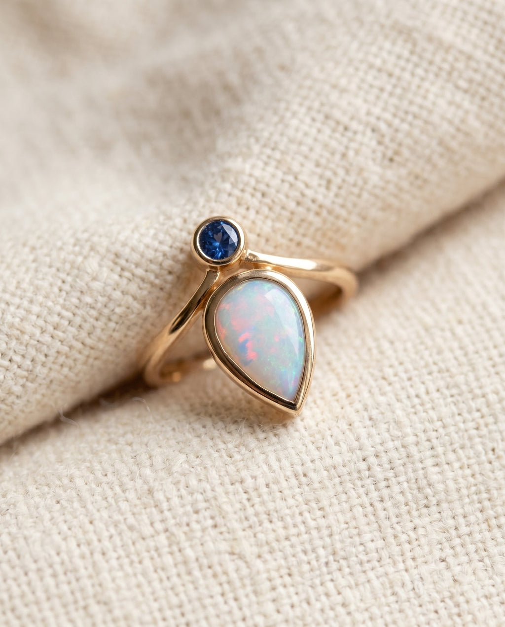 By Sophi Vintage Blue Opal Ring in Gold flat-lay on warm cream