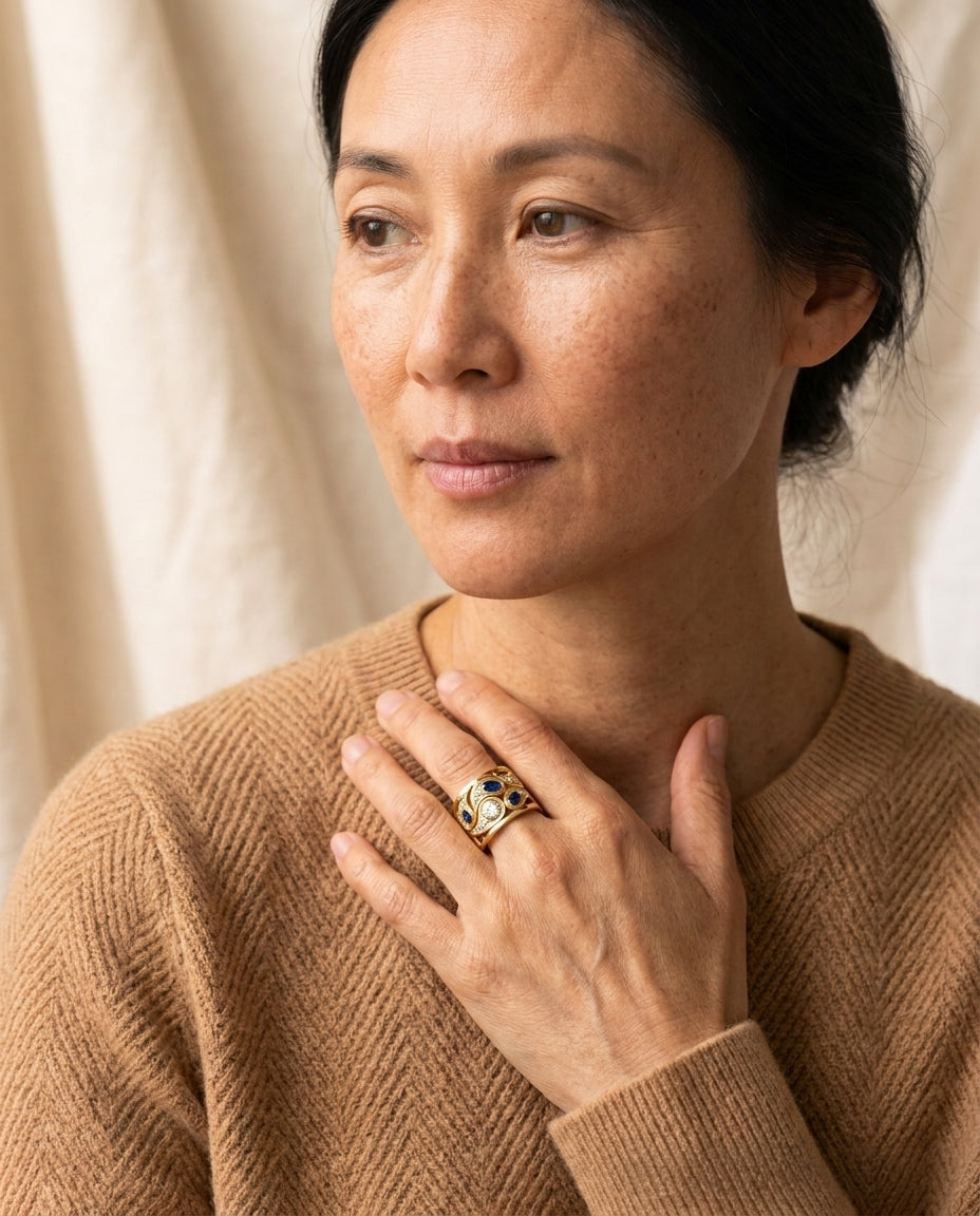 By Sophi Vintage Blue Zirconia Ring in Gold, editorial portrait worn with warm camel knit
