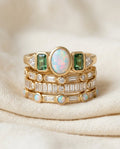 Vintage opal and zirconia stacking ring set on cream textile, four gold-tone bands with mixed-stone tops