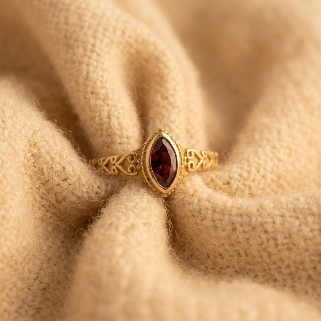 By Sophi Vintage Red Inlaid Stone Gold Ring, three-quarter view on warm cream wool