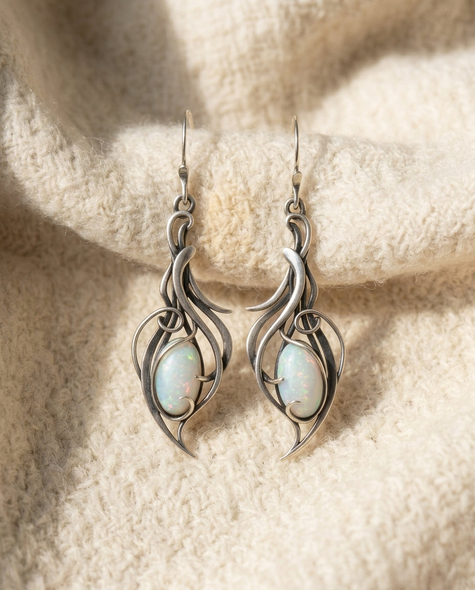 By Sophi Vintage White Opal Silver Scroll Earrings flat-lay on warm cream wool