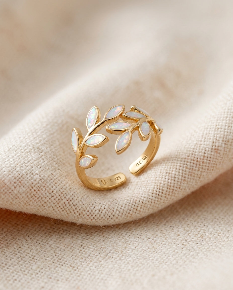 White opal leaf adjustable ring in gold on cream textile, olive-branch laurel design
