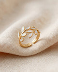 White opal leaf adjustable ring in gold on cream textile, olive-branch laurel design